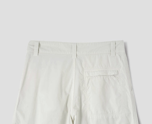 Off white cotton trousers, finished with one stitch-through back pocket with a concealed Vislon zip fastening, back flat lay view.