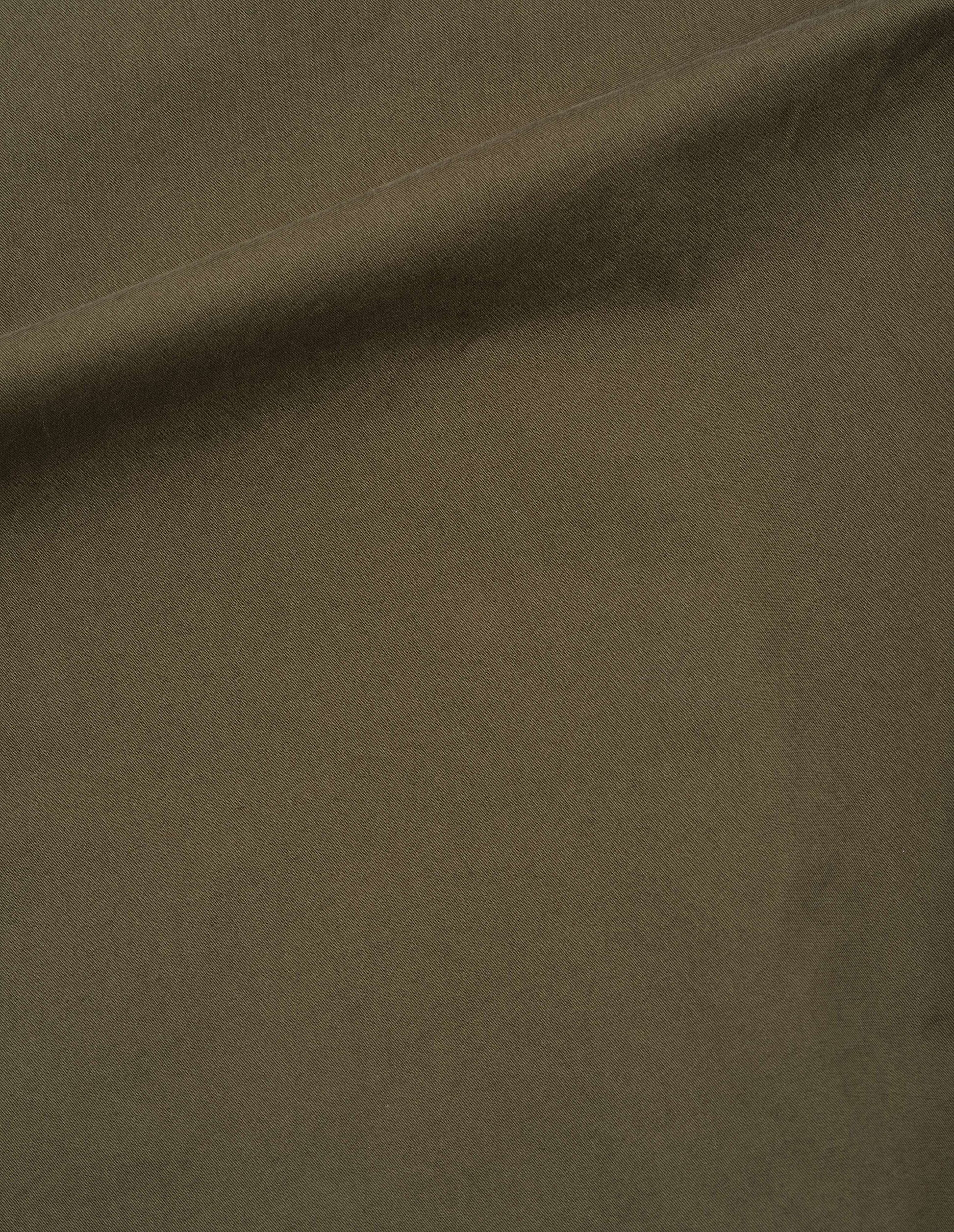 Brownish green cotton pleated trousers, fabric swatch.