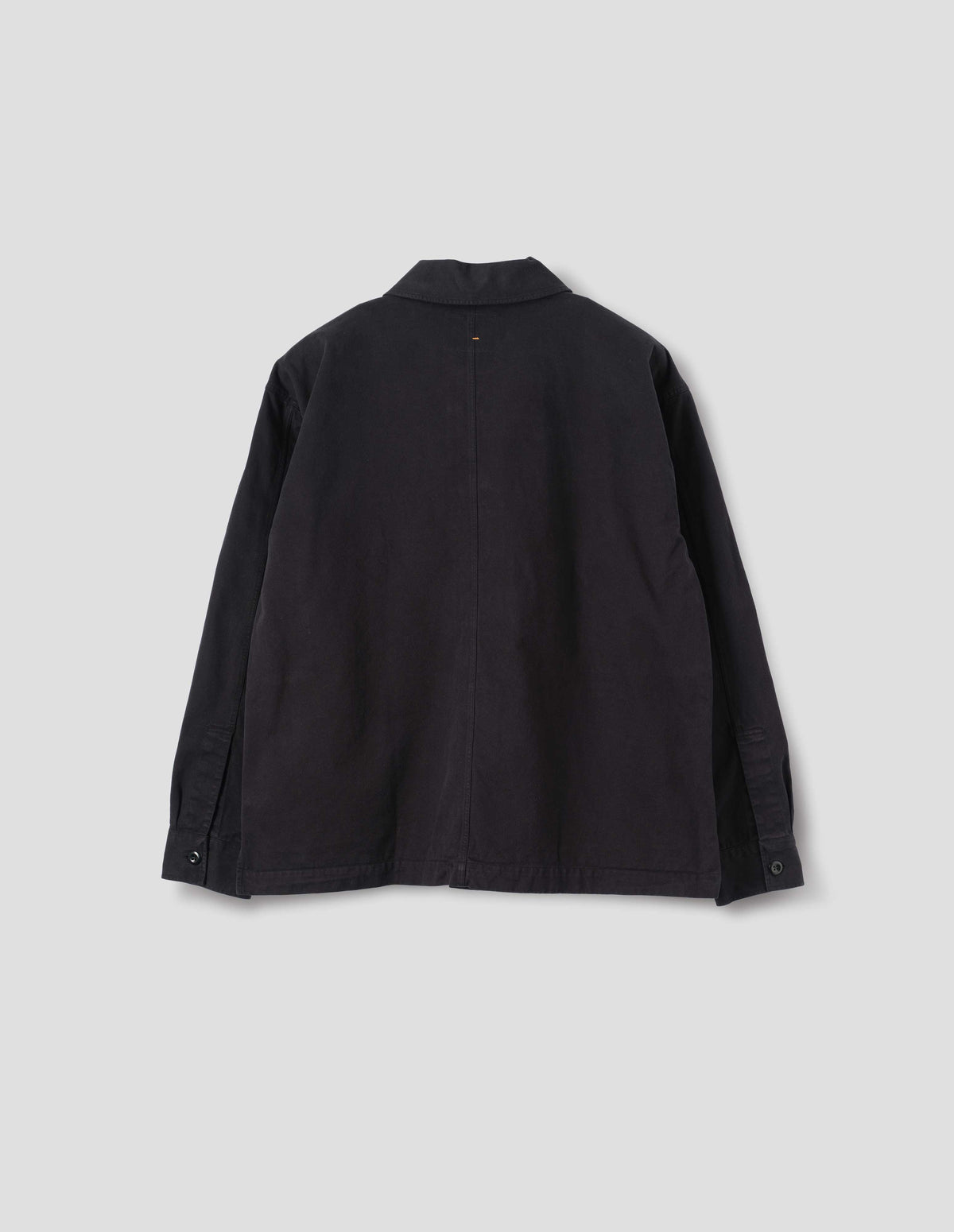Black cotton overshirt, with button closure shirt cuffs and centre back seam. Back flat lay view. 