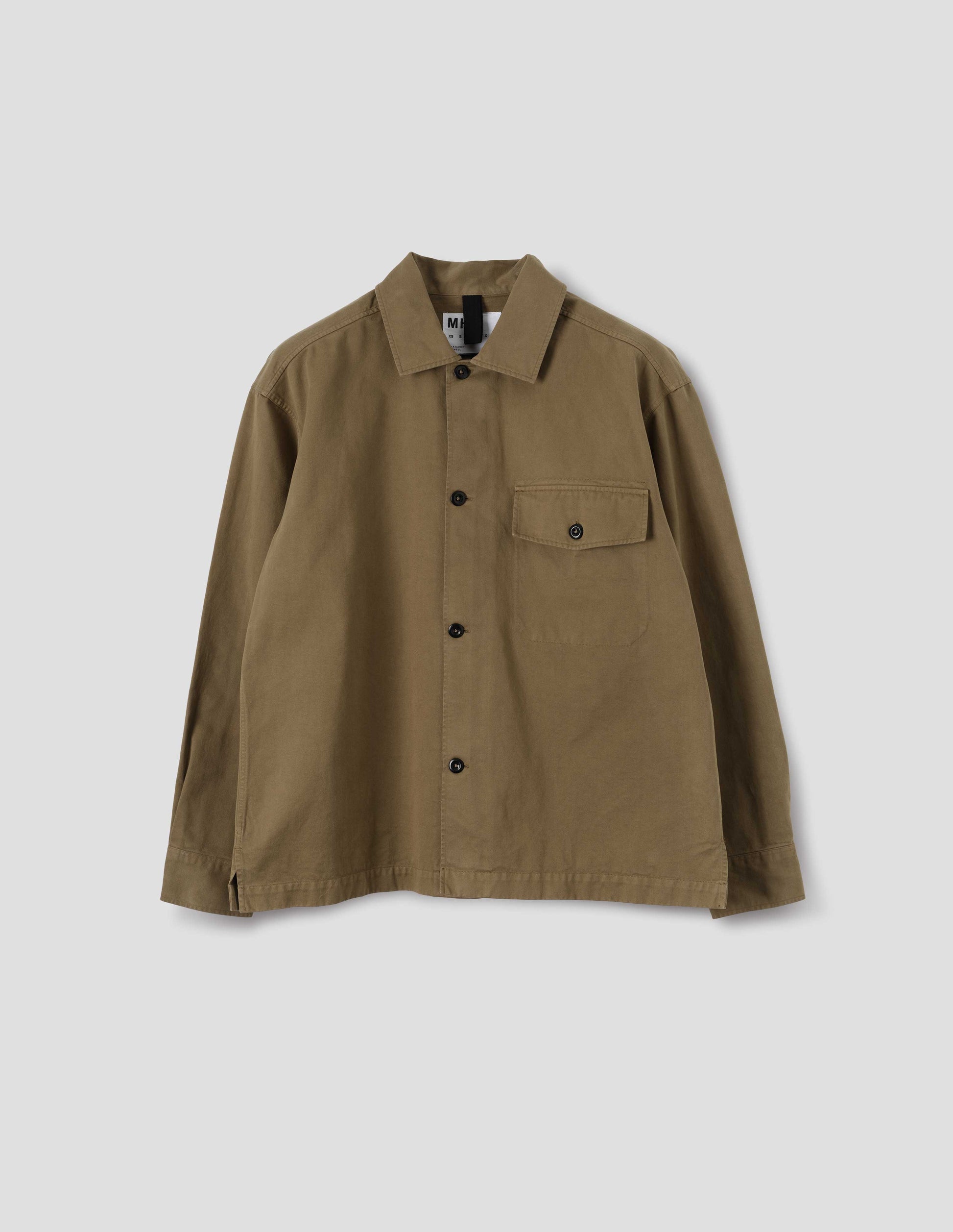 Brownish green cotton overshirt, with a grown-on, button-fastening placket, spread collar, and welt chest pockets with flaps and button closure, finished with shirt cuffs. Front flat lay view. 