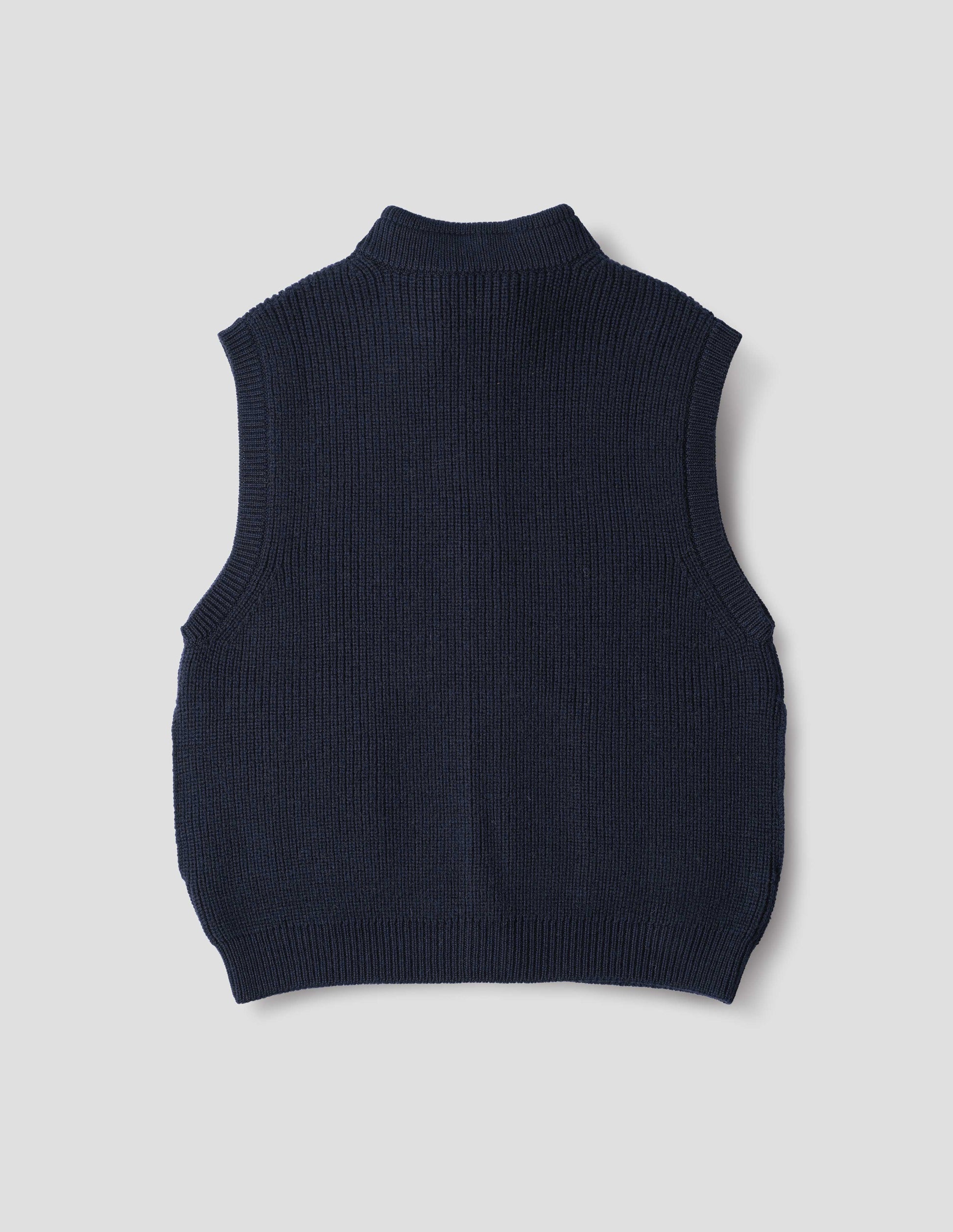 Dark blue wool gilet, with rib neck, armholes and hem, back flat lay view.