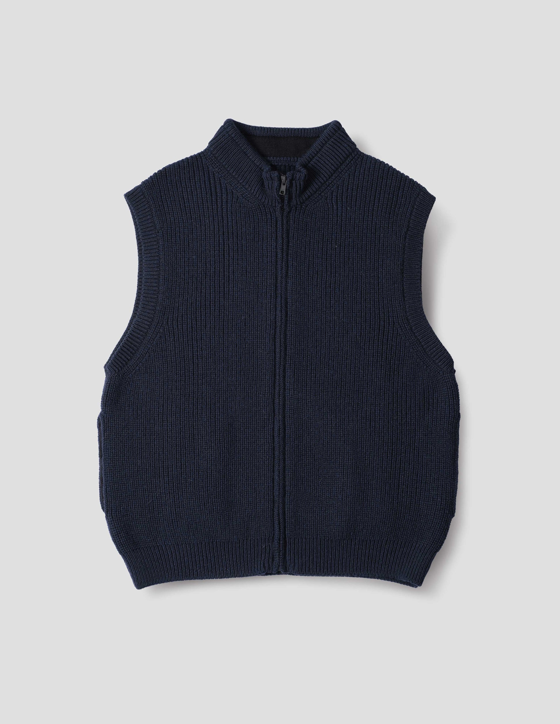 Dark blue wool gilet, with rib neck, armholes and hem, and  zip, front flat lay view.