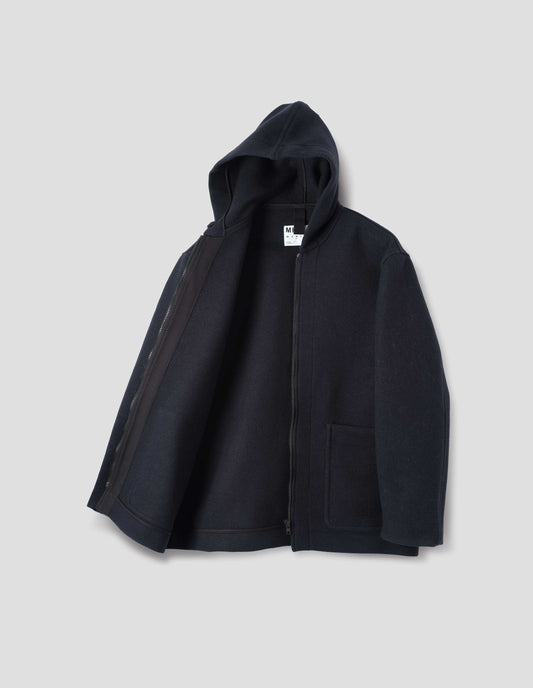 Dark navy zip through wool coat, with a hood, two laid-on patch pockets, straight cuffs and hems. Open flat lay view.