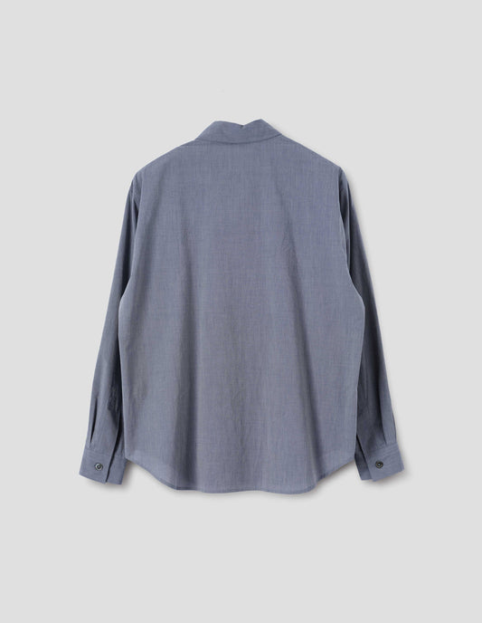 Blue cotton shirt with mother of pearl buttons on cuffs and curved hem. Back flat lay view.