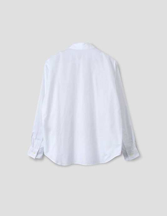 White cotton shirt with mother of pearl buttons on cuffs and curved hem. Back flat lay view.