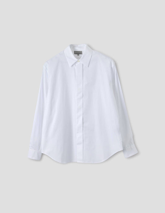 White cotton shirt with concealed button placket and mother of pearl button on collar, hanger loop on back neck and curved hem. Front flat lay view.