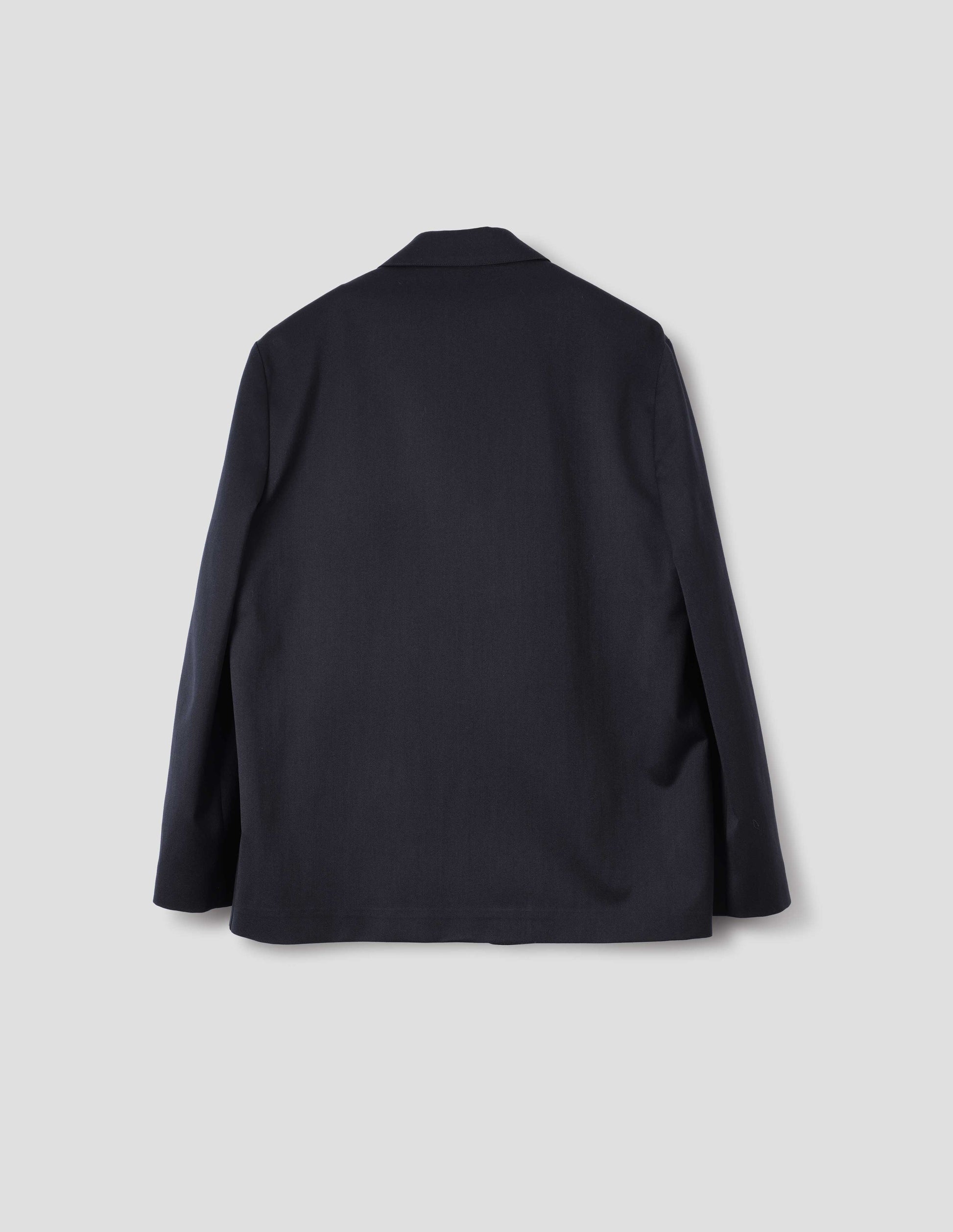 Dark blue wool cotton blazer with dropped shoulders. Back flat lay view.