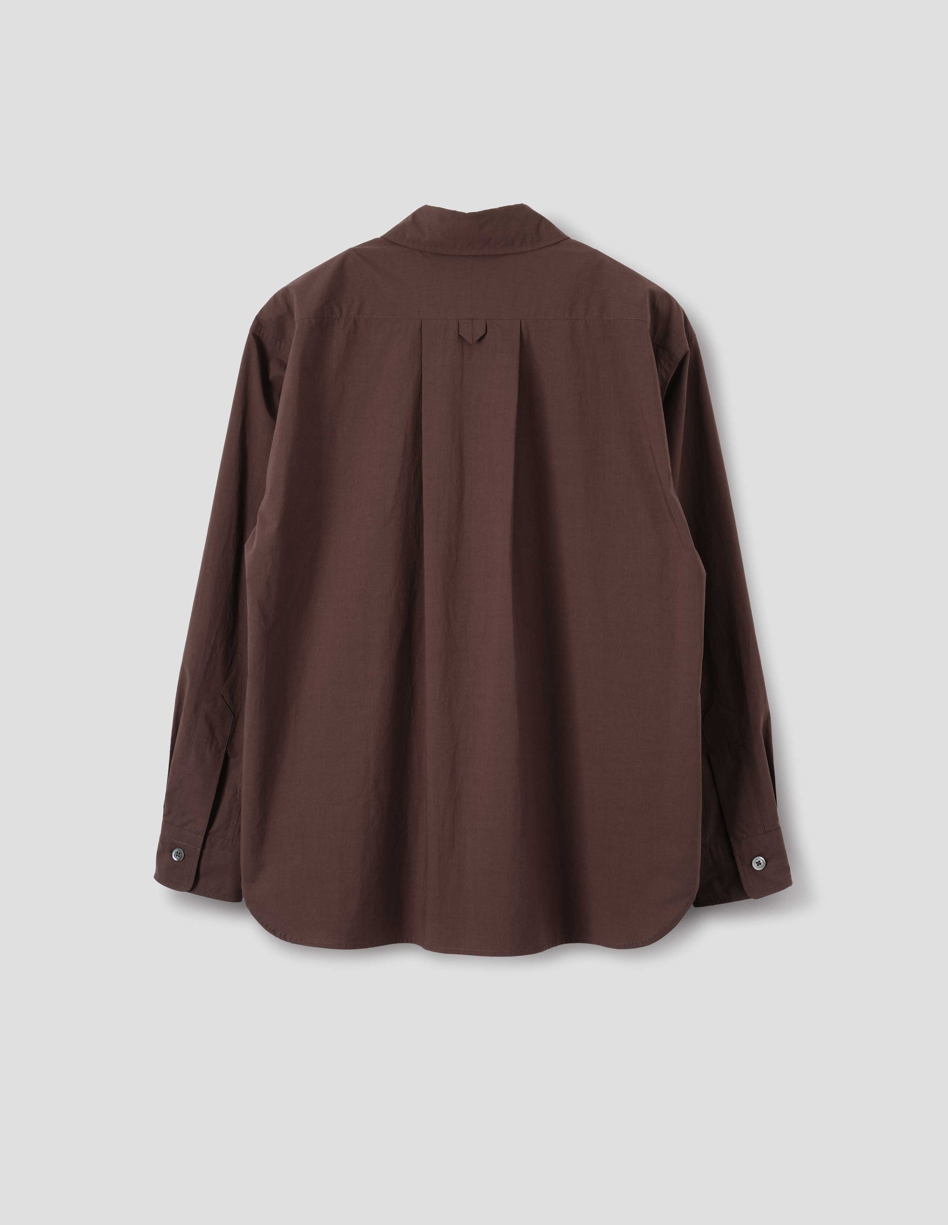 Brown cotton shirt with split yoke and hanger loop detail on back, mother of pearl buttons on cuffs and curved hem. Back flat lay view.