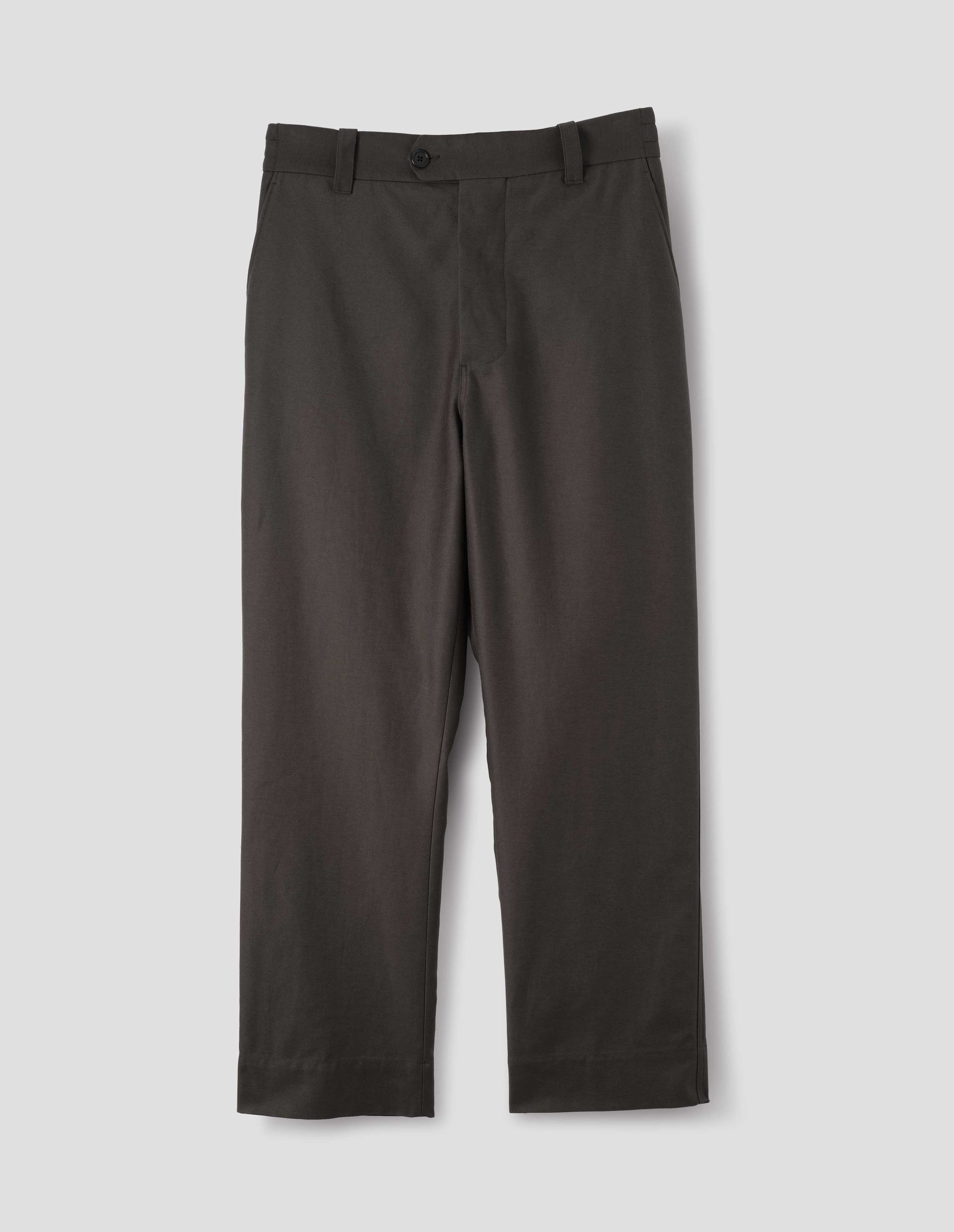 Grey cotton trousers with half-elasticated extended waistband with belt loops, horn button fastening and slant side pockets. Front flat lay view.