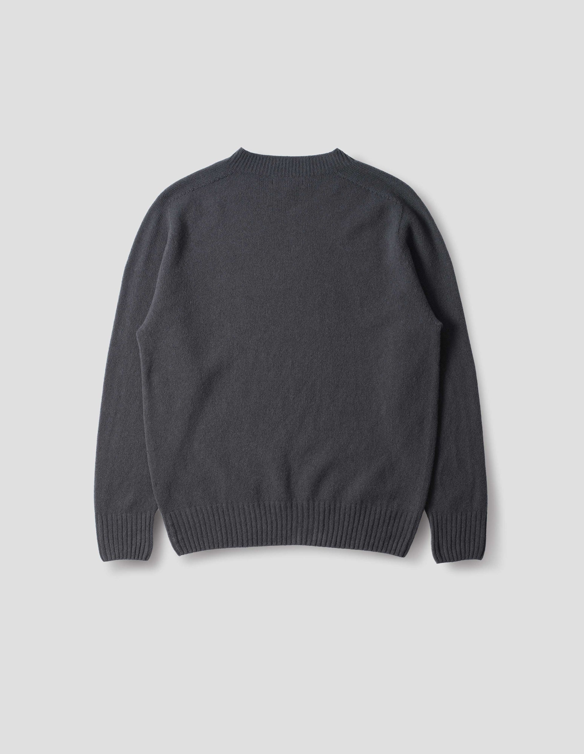 Dark grey merino cashmere seamless jumper with ribbed crew neck, cuffs and hem. Back flat lay view.