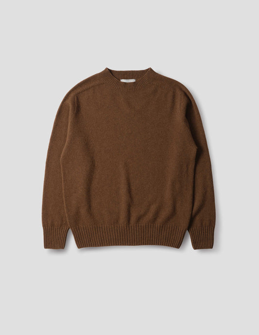 Brown merino cashmere seamless jumper with ribbed crew neck, cuffs and hem. Front flat lay view.