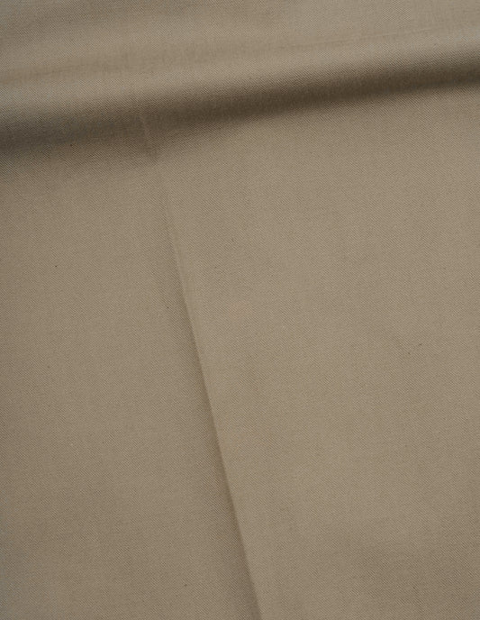 Beige dense cotton drill trousers fabric swatch.