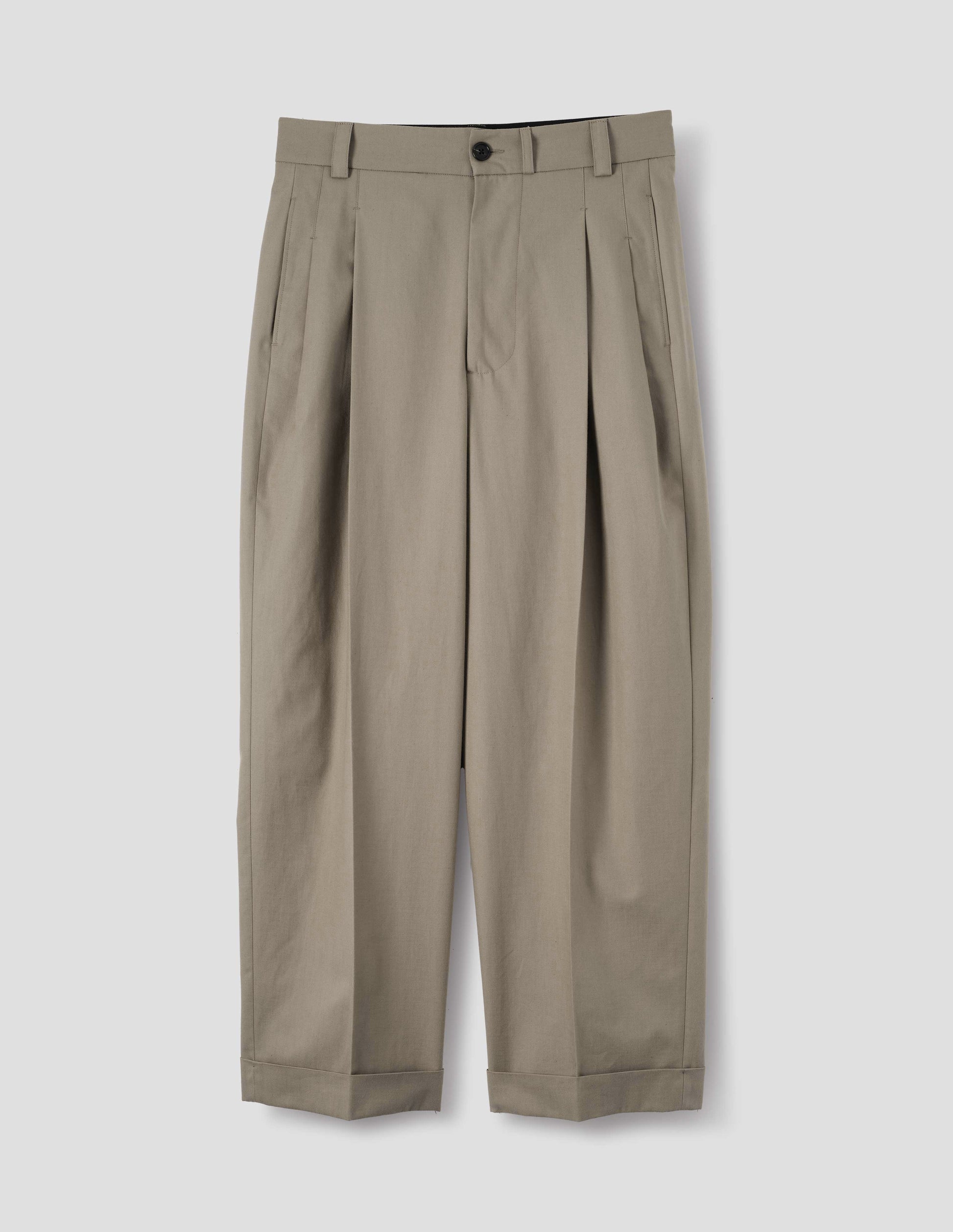 Beige cotton pleated trousers with horn button-through waistband with belt loops, concealed side pockets and cuffed hem. Front flat lay view.