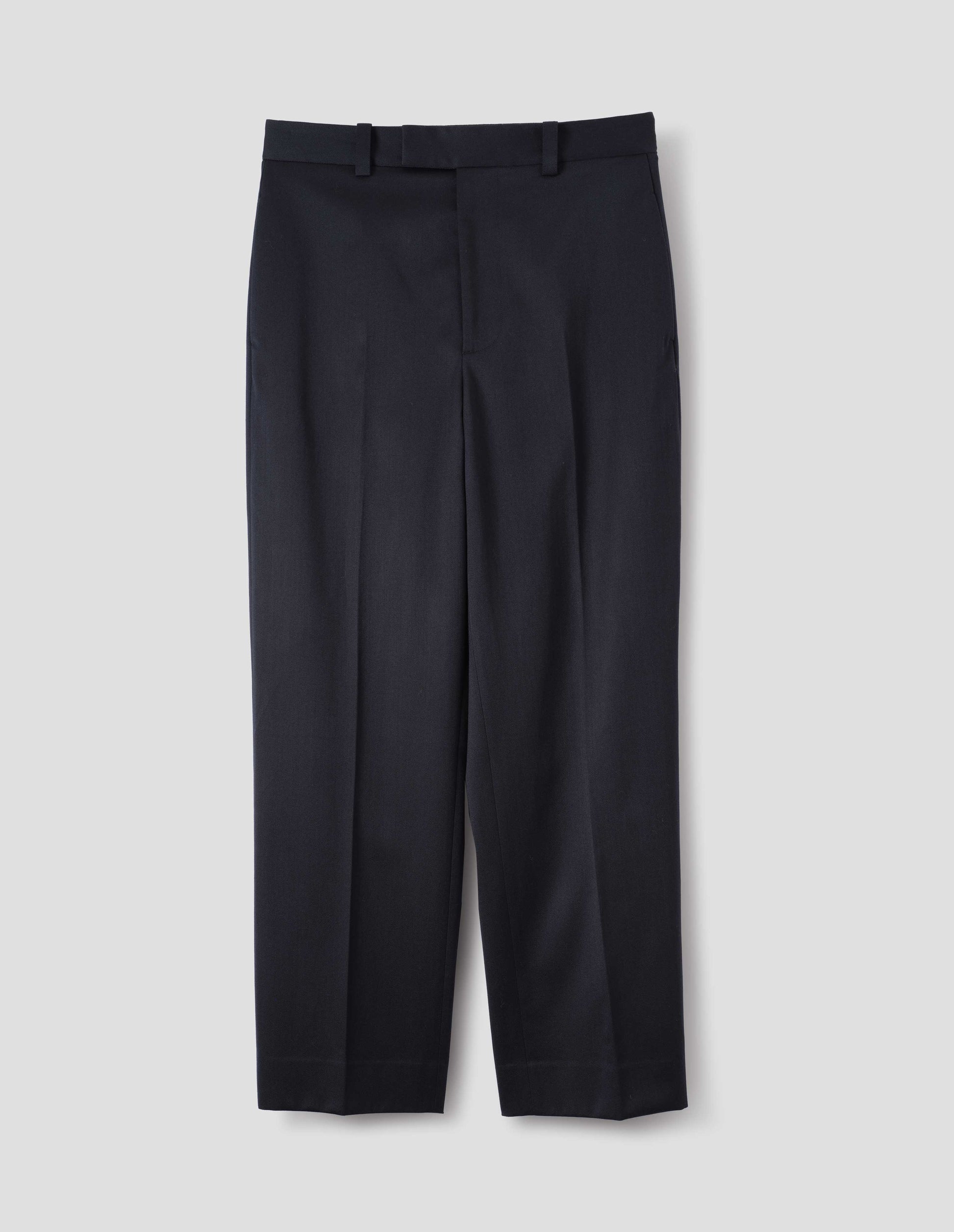 Dark blue wool cotton trousers with belt loops and waistband extension with hook and bar fastening. Front flat lay view.