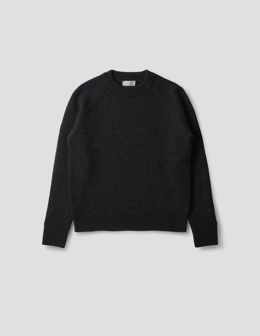 Dark grey wool jumper with raglan sleeves, tubular collar and rib detailing at hem and cuffs. Front flat lay view.