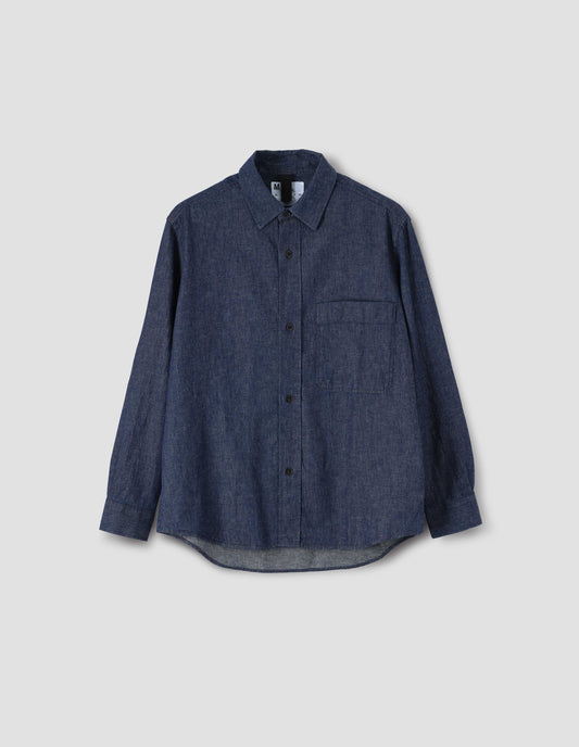 Indigo blue long sleeve shirt with raised placket, chest pocket and side gusset stitch detailing. Front flat lay view.