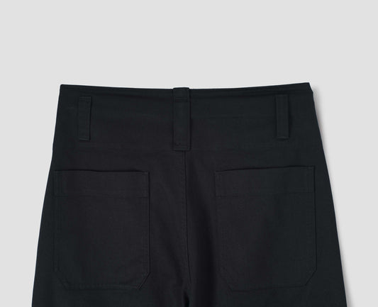 Dark navy relaxed cut trousers, with dropped belt loops and patch back pockets. Back flat lay view.