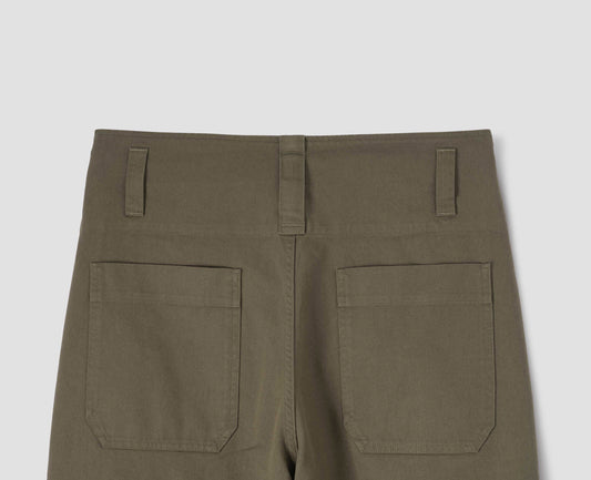 Green relaxed cut trousers, with dropped belt loops and patch back pockets. Back flat lay view.