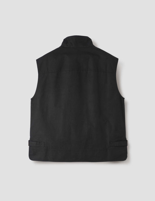 Black sleeveless jacket with with stepped back hem and side cinch adjusters, back flat lay view. 