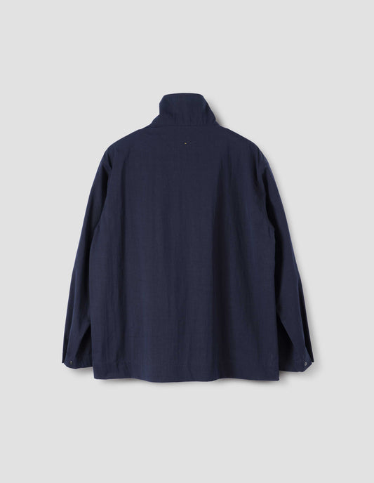 Navy blue anorak with stand collar and  popper fastening adjustable cuffs, back flat lay view.