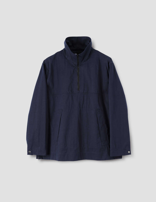 Navy blue anorak with half zip closure, stitch-through flap kangaroo pockets and  popper fastening adjustable cuffs, front flat lay view.