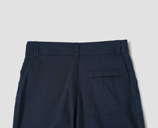 Dark navy trousers with zip fly back pocket, belt loops and slant pockets. Back flat lay view.