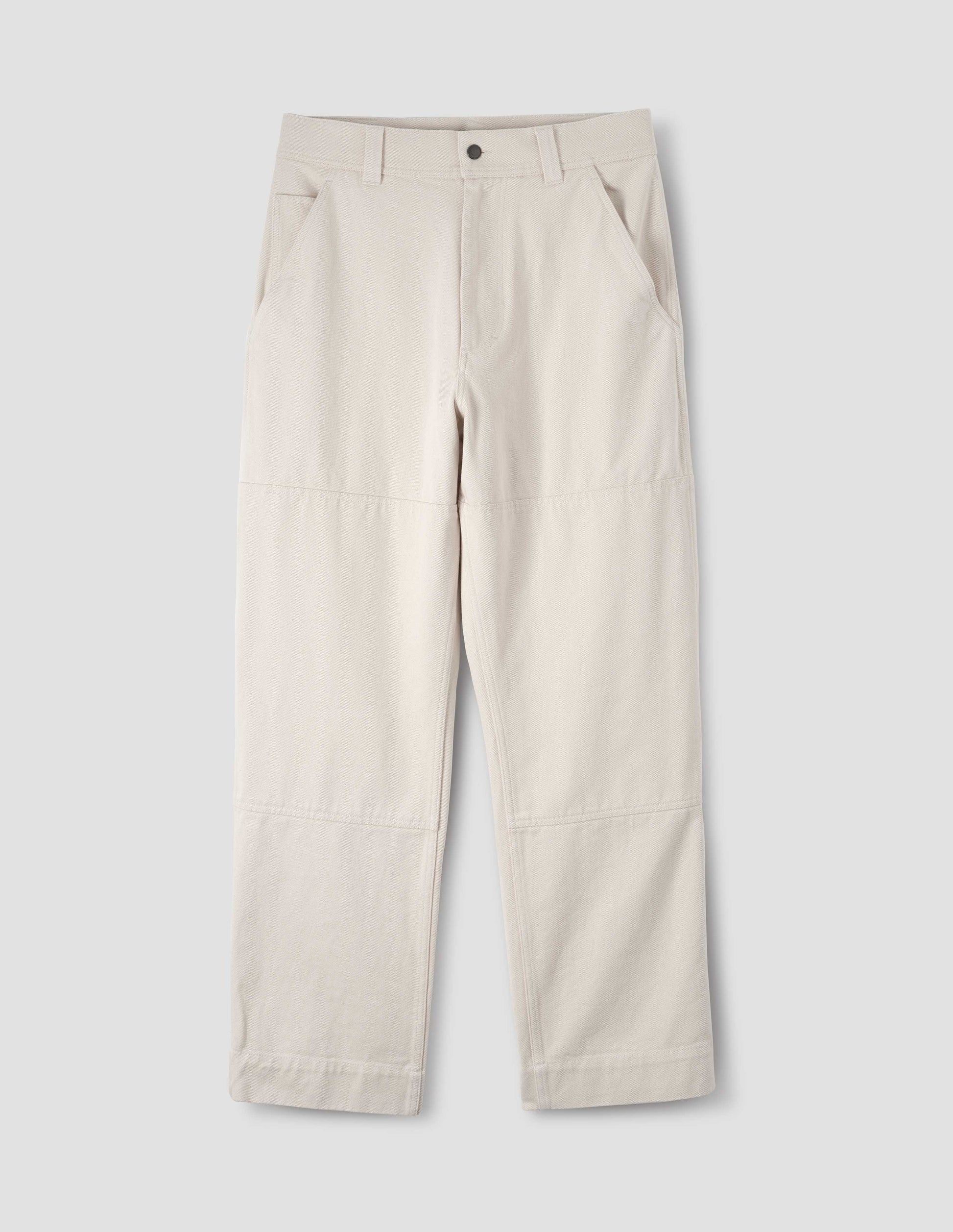 Off white trousers with large knee patches, slant pockets, belt loops, zip fly and double tool pocket on the side leg. Front flat lay view.