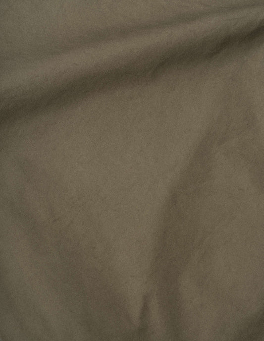 Green elasticated waist trousers, cotton blend cordura fabric swatch.