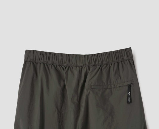 Green/brown lightweight trousers with elasticated waist and zip back pocket. Back flat lay view.