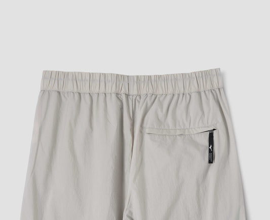 Light grey lightweight trousers with elasticated waist and zip back pocket. Back flat lay view.