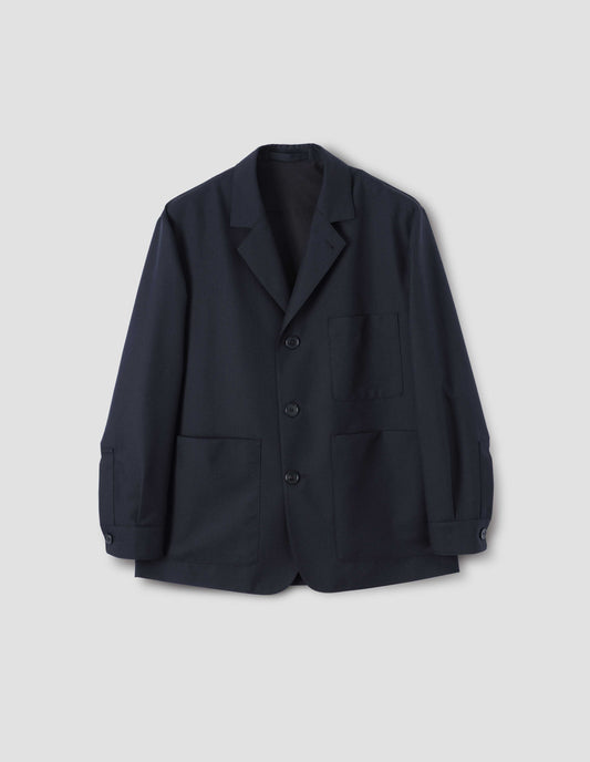 Dark navy blazer with horn button closure and cuffs and patch pockets, front flat lay view.