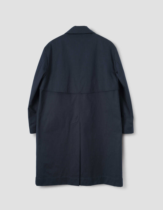 Navy blue longline mac with horn button cuffs and  button fastening deep back vent, back flat lay view.