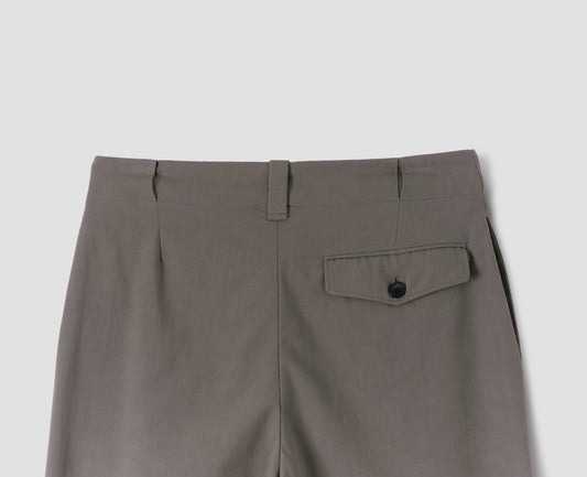 Grey/beige single pleated trousers, with wide belt loops and  button-through jet flap back pocket. Back flat lay view.