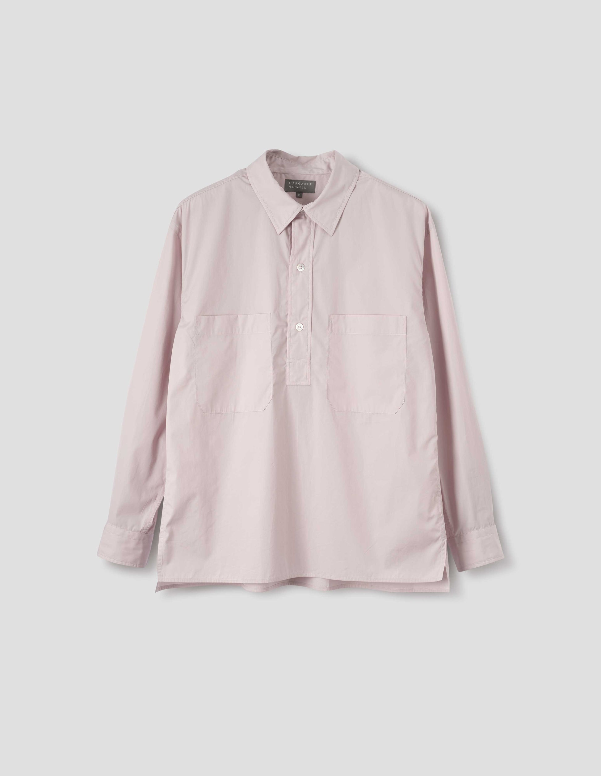 Pink cotton long sleeve shirt with stitch through raised placket, front patch pockets and deep side split vents. Front flat lay view.