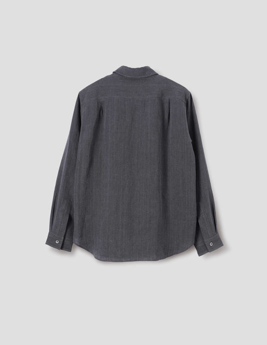 Dark grey cotton long sleeve shirt, with mother of pearl button cuffs and pleats on back yoke. Back flat lay view.