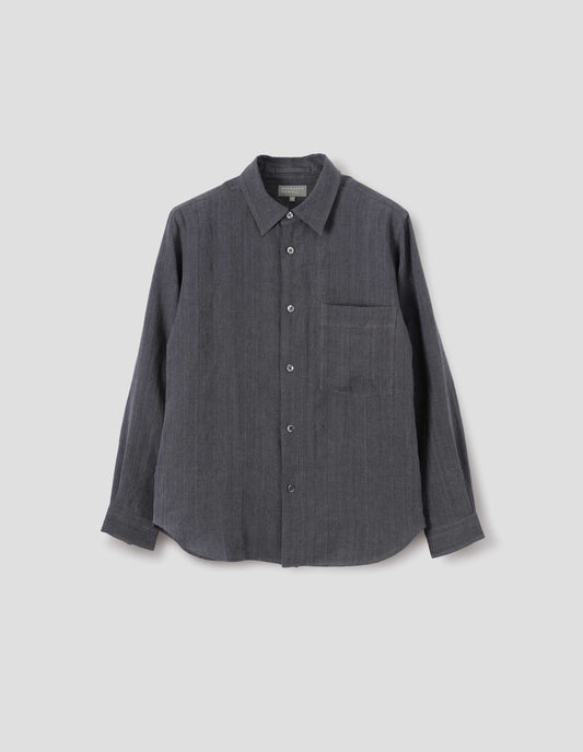 Dark grey cotton long sleeve shirt, with mother of pearl buttons, curved hem and chest patch pocket. Front flat lay view.