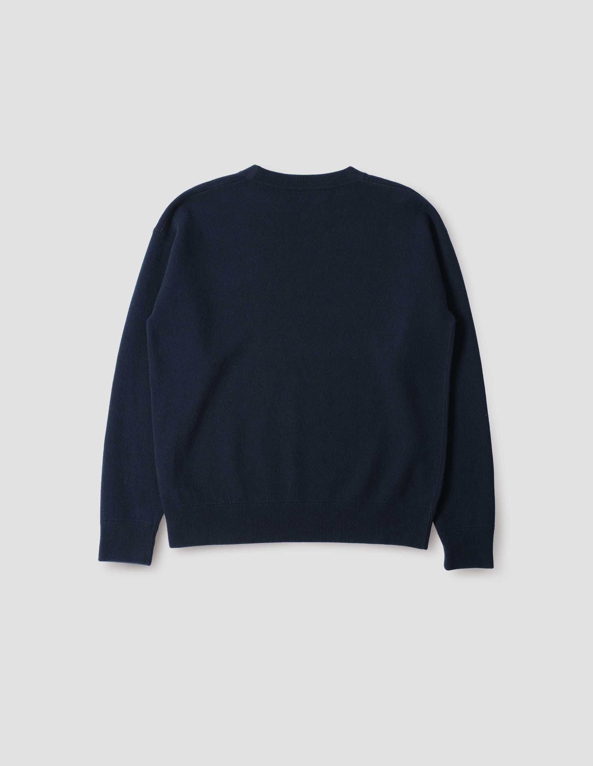 Dark blue knitted sweatshirt with rib collar, cuffs and hem. Back flat lay view.
