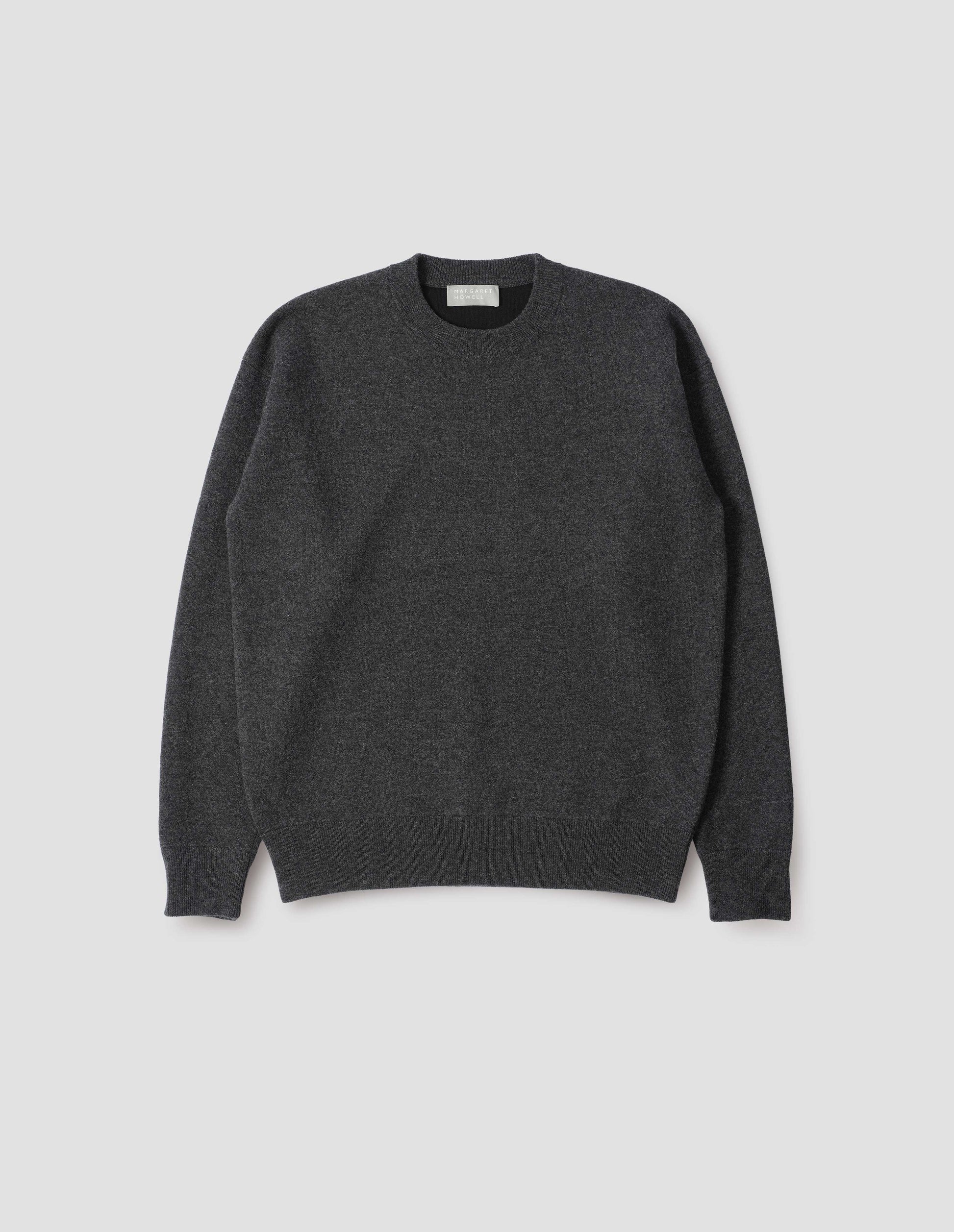 Dark grey knitted sweatshirt with rib collar, cuffs and hem. Front flat lay view.