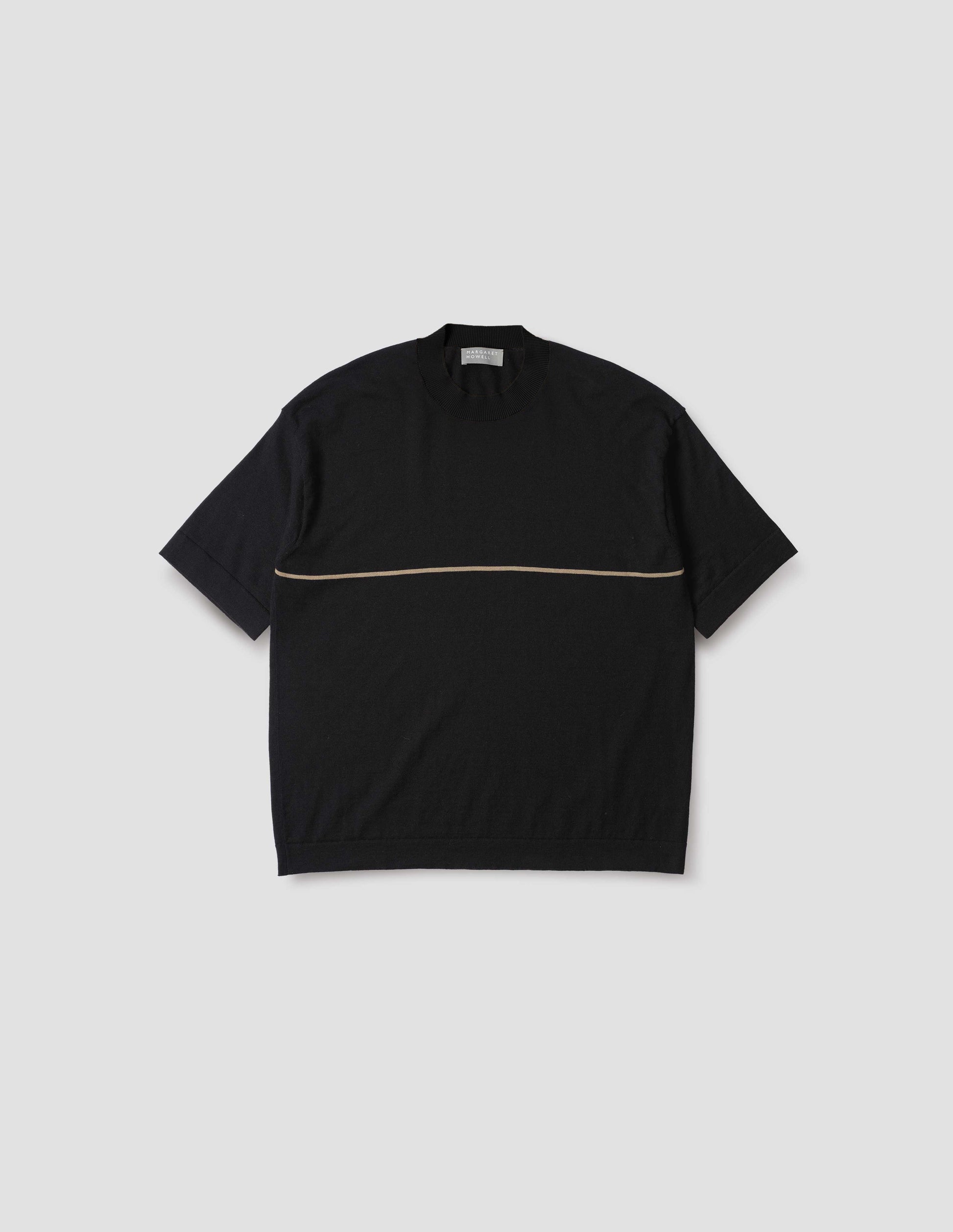 Black knitted t-shirt with deep rib crew neck, set in sleeves and single dark beige stripe across body. Front flat lay view.