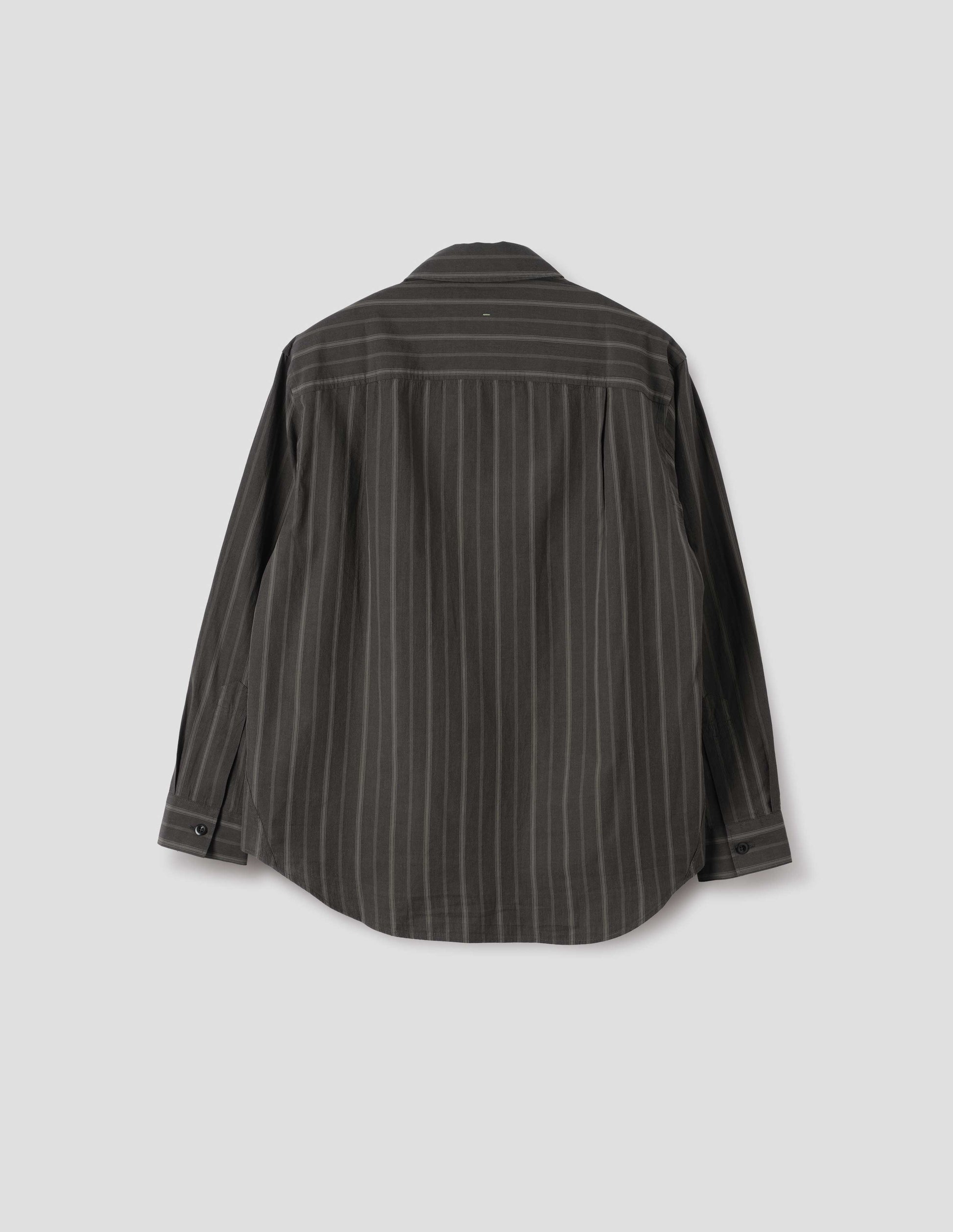 Off black and khaki striped shirt, with corozo button cuffs, side pleats on back yoke and elongated curved hem. Back flat lay view. 