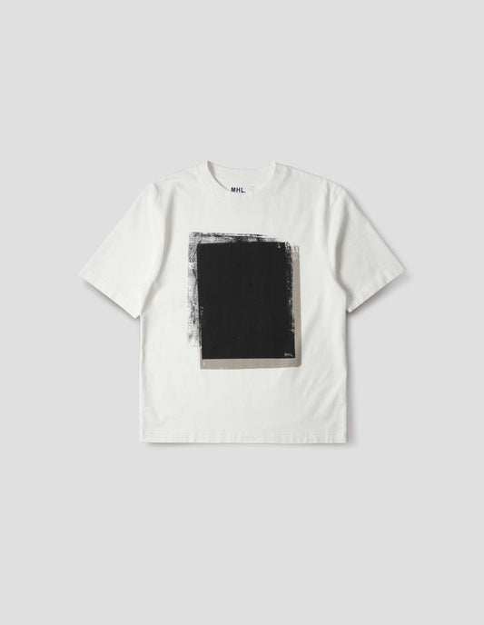 Off white short sleeve t shirt with black abstract block printed on the front. Front flat lay view. 