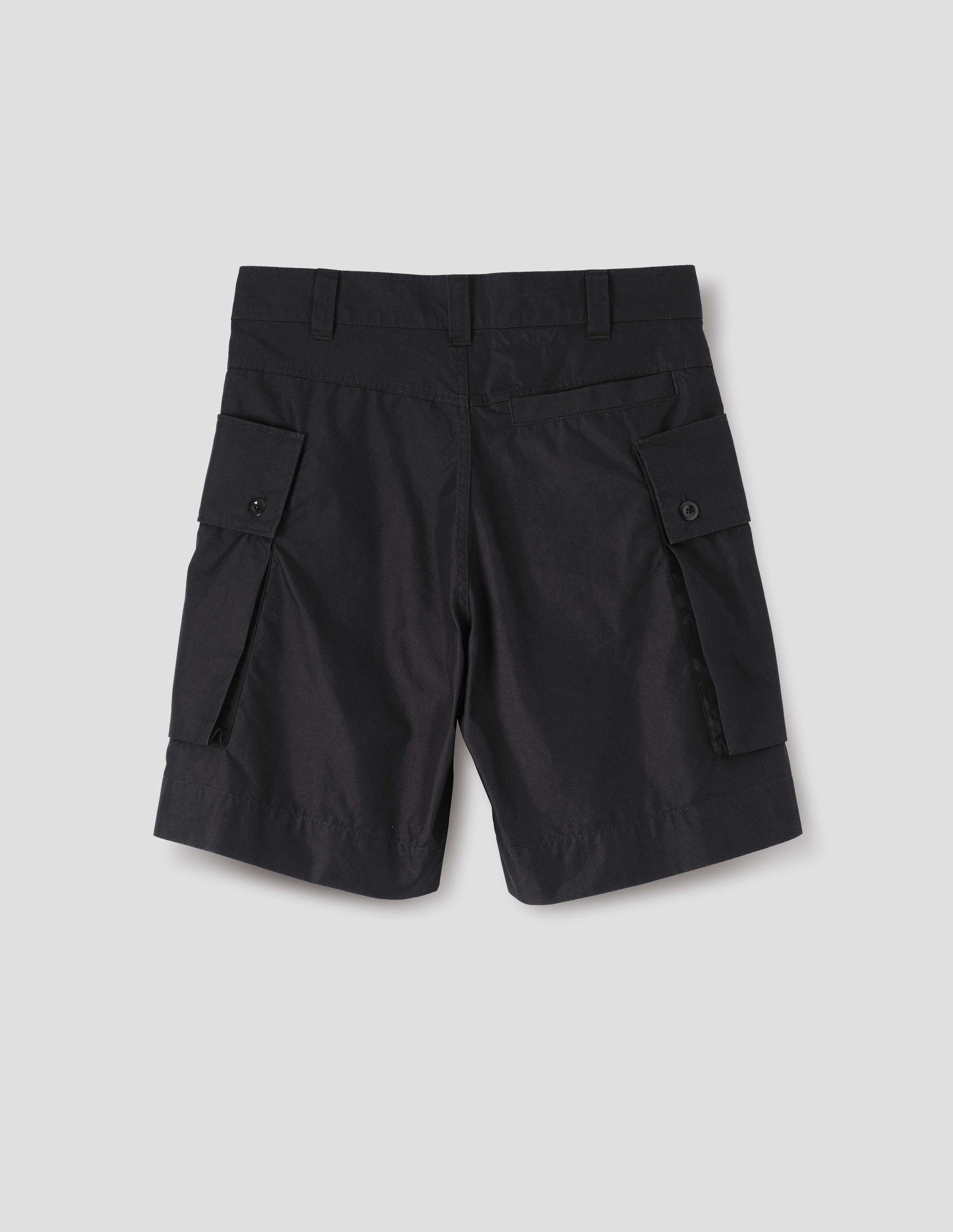 Black cotton shorts with cargo pockets, belt loops and welt back pocket. Back flat lay view. 