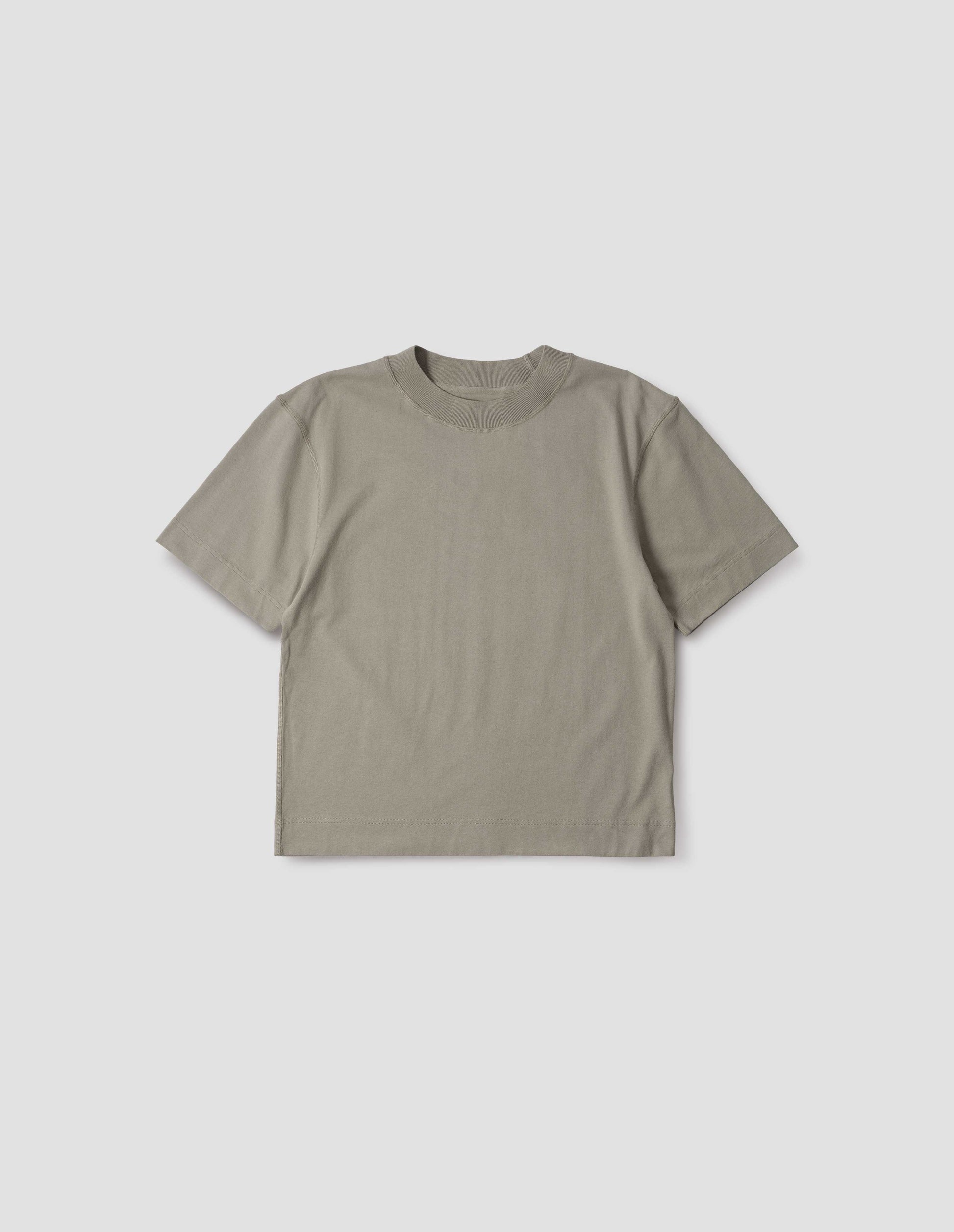 Greenish beige short sleeve t-shirt with dropped shoulder and rib neck. Front flat lay view.
