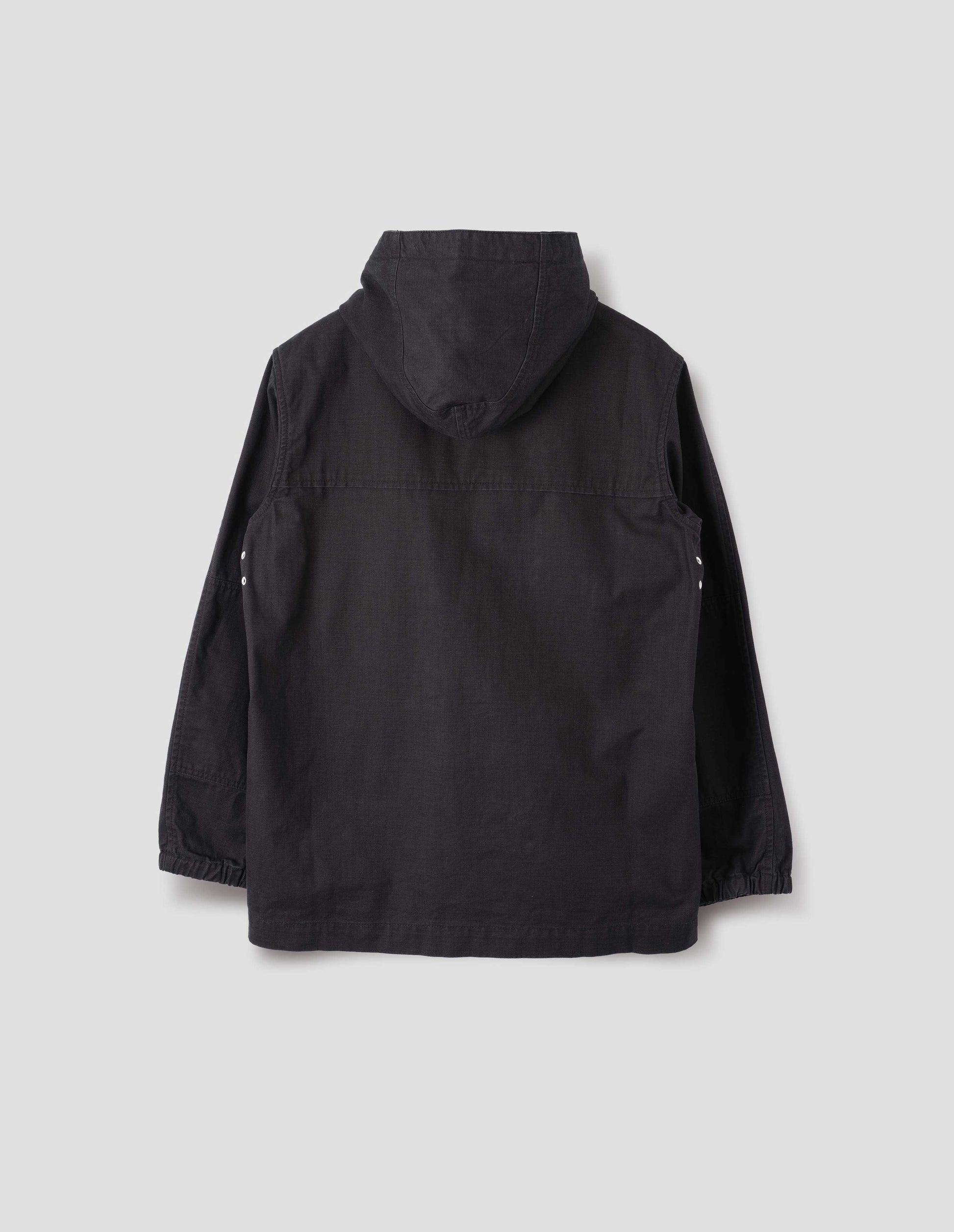 Indigo blue twill hooded jacket, with metal underarm vents and elasticated cuffs. Back flat lay view. 