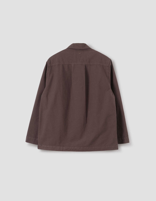 Brown shirt with straight cuffs, side split hem and box pleat on back yoke. Back flat lay view.