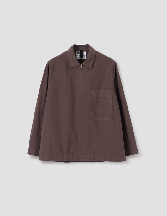 Brown shirt with wide stitch-through placket with half zip, large patch chest pocket, straight cuffs and and side split hem. Front flat lay view.