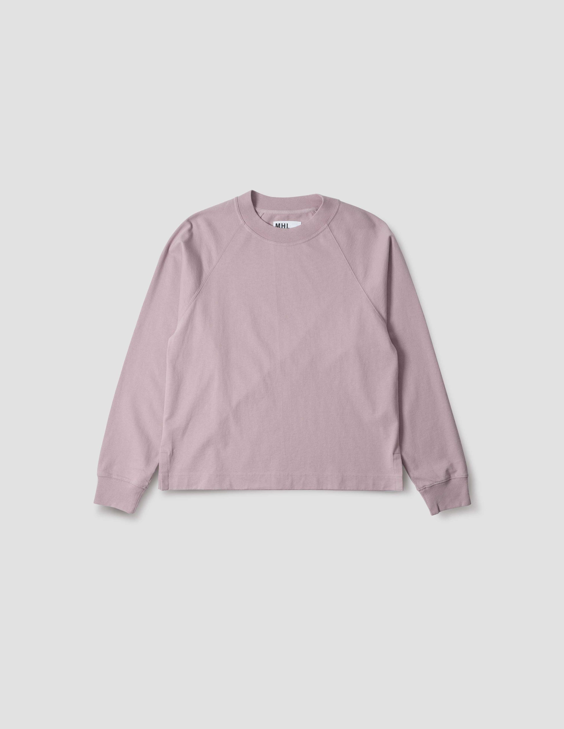 Pink cotton long sleeve t-shirt with raglan sleeve, single rib trims on neck and cuffs and vent split hem. Front flat lay view.