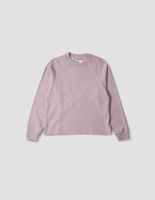 Pink cotton long sleeve t-shirt with raglan sleeve, single rib trims on neck and cuffs and vent split hem. Front flat lay view.