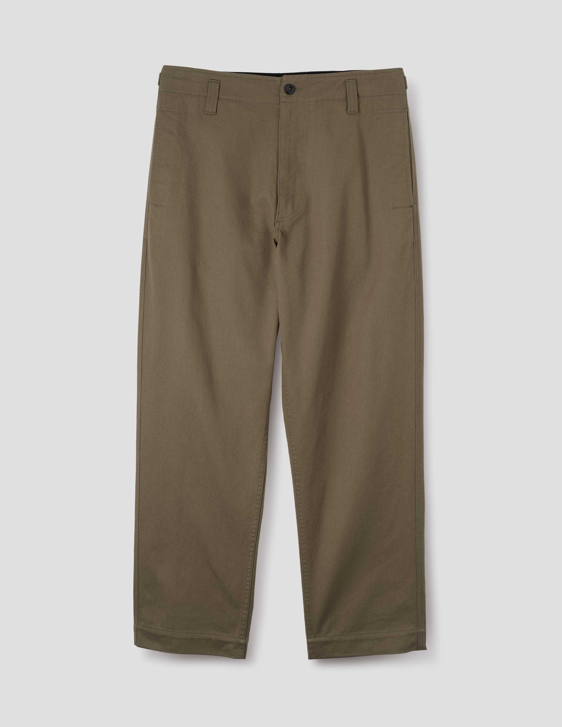 Green cotton drill trousers with belt loops, slant side pockets and corozo button fastening. Front flat lay view.