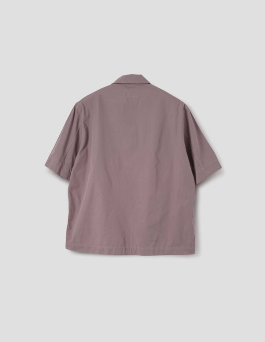 Pink cotton short sleeved polo shirt with side split hem. Back flat lay view.